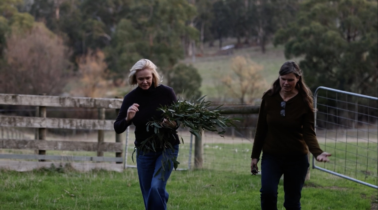 Sally and Heather walking with gathered plants