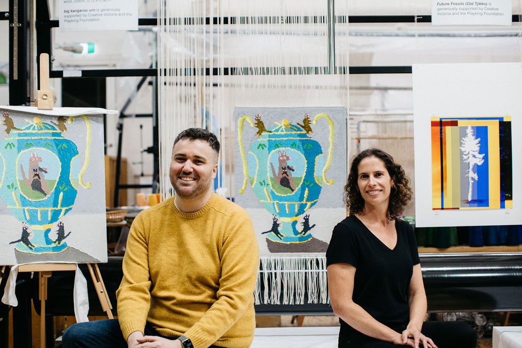 Troy Emery and Emma Sulzer in front of the 'big kangaroo urn' tapestry, designed by Troy Emery in 2021. Photograph courtesy of Marie-Luise Skibbe.