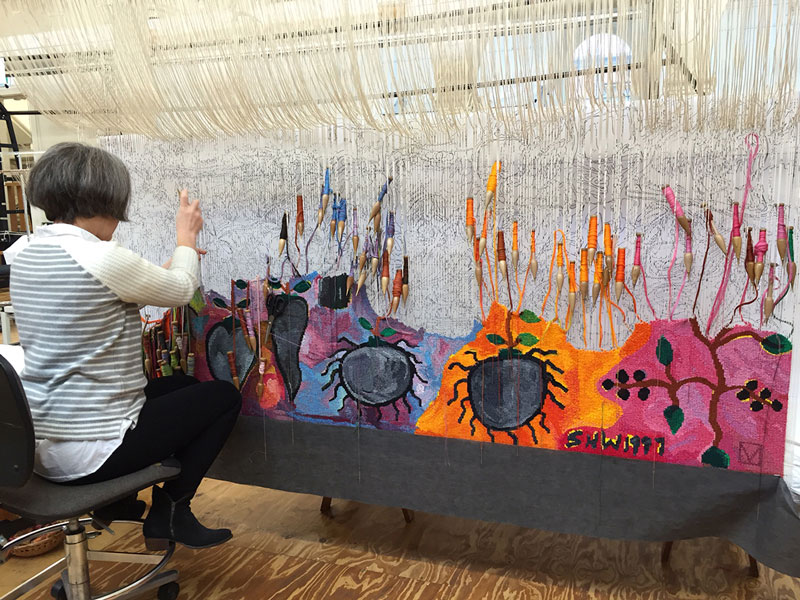 ATW weaver Pamela Joyce working on 'Gordian Knot' designed by Keith Tyson in 2016 and woven by Chris Cochius, Pamela Joyce and Cheryl Thornton. Photograph: ATW.
